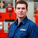 Portrait of Ian Macdonald, a marine safety officer, looking attentive and professional.